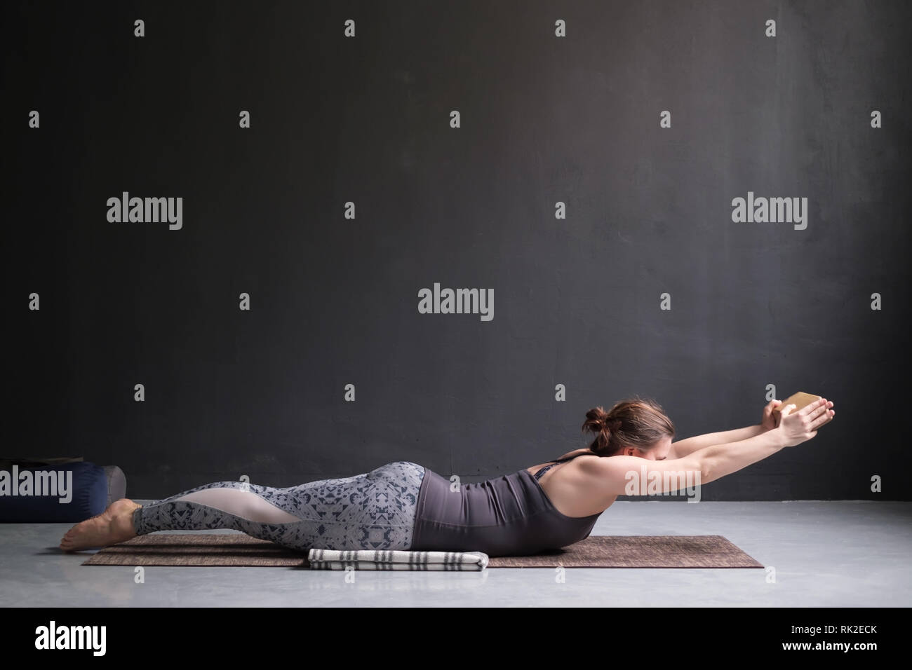 Frau Üben Yoga, Stretching in Salabhasana übung, Double Leg Kicks darstellen Stockfoto