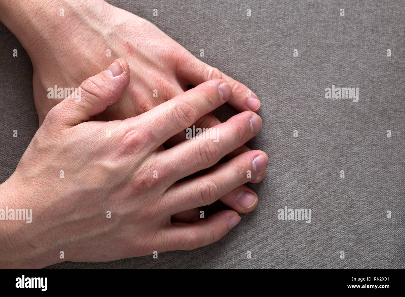 Nahaufnahme der männlichen männliche Jugendliche Arbeiter Hände mit rauher Haut und kurze Fingernägel auf ebenem Kopie Raum Hintergrund, Ansicht von oben. Die manuelle Arbeit und Stockfoto