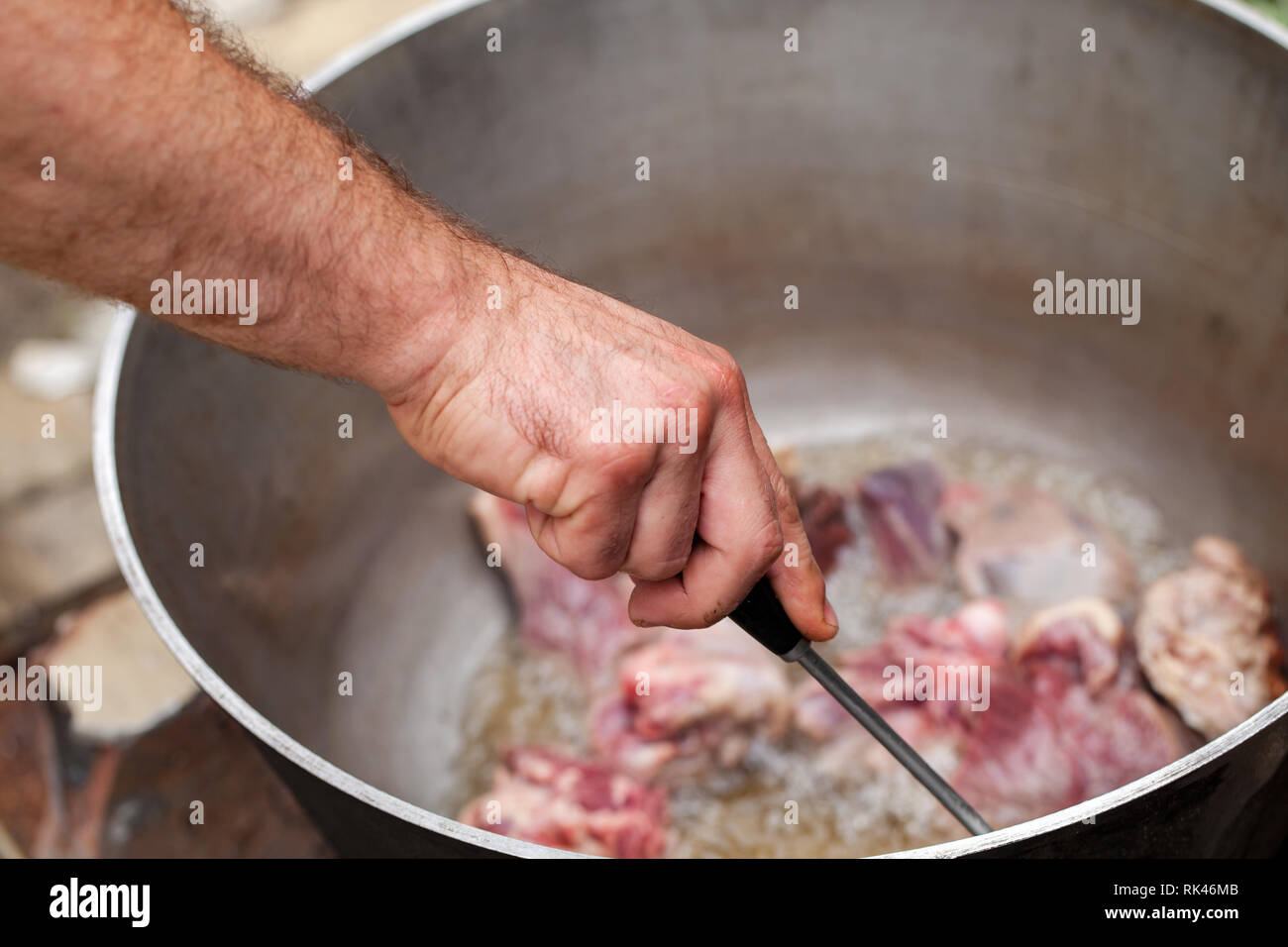 Koch mixe Lamm Stücke in Kessel. Vorbereitung der Chorba Suppe auf offenem Feuer Stockfoto