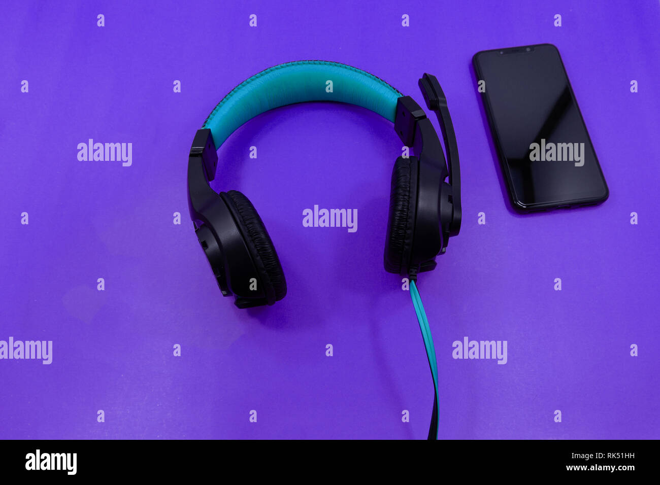 Mobiltelefon mit weißen Ohrhörer auf Farbe backgroung, Ansicht von oben Stockfoto