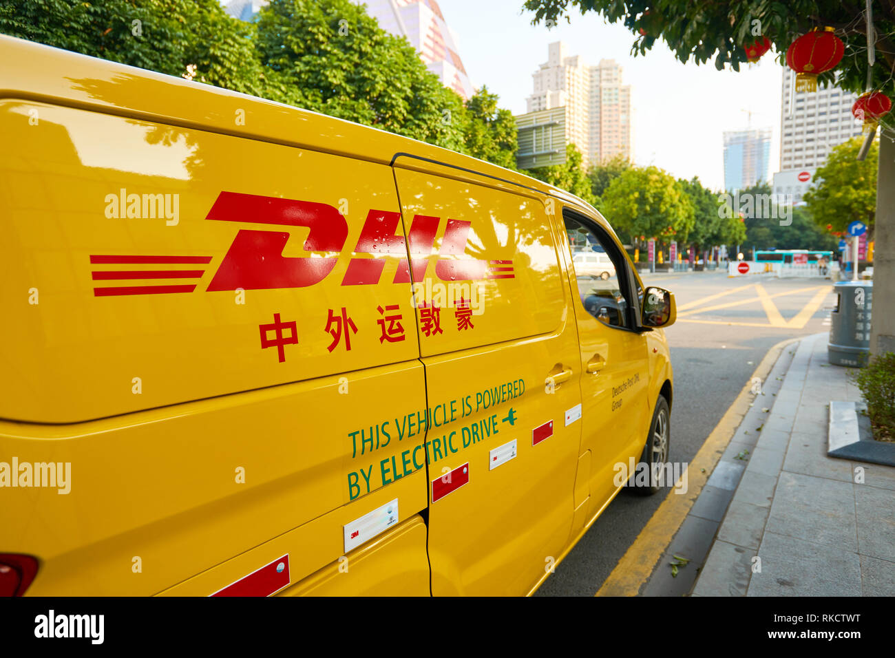 SHENZHEN, China - Februar 05, 2016: DHL-Auto auf der Straße. DHL Express ist eine Abteilung des Deutschen Logistikunternehmen Deutsche Post DHL bietet in Stockfoto