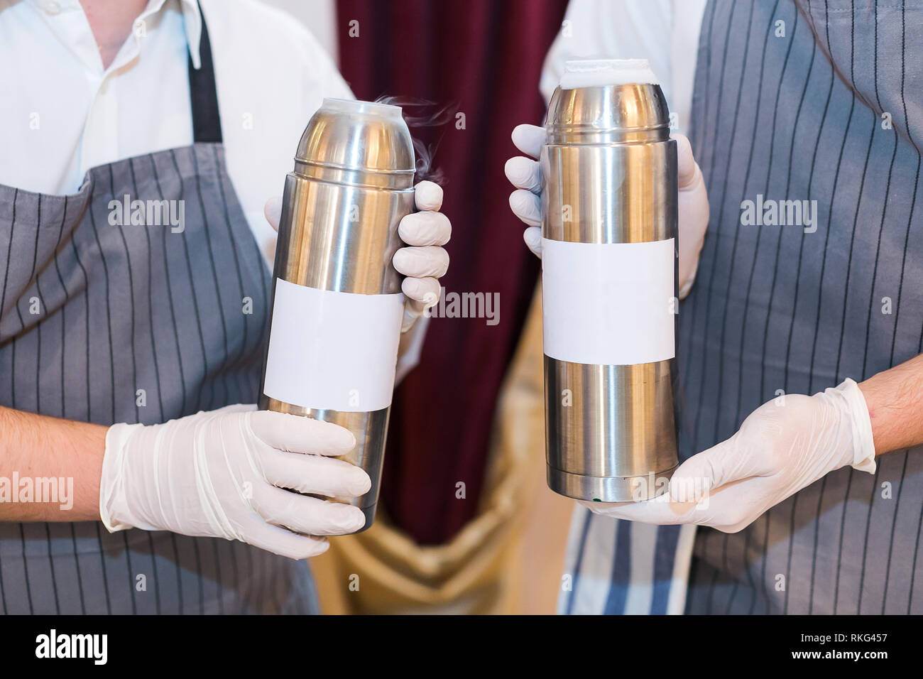 Zwei Barkeeper holding Schüttler mit flüssigem Stickstoff hautnah. molekulare Küche. Zubereitung von Cocktails. Stockfoto