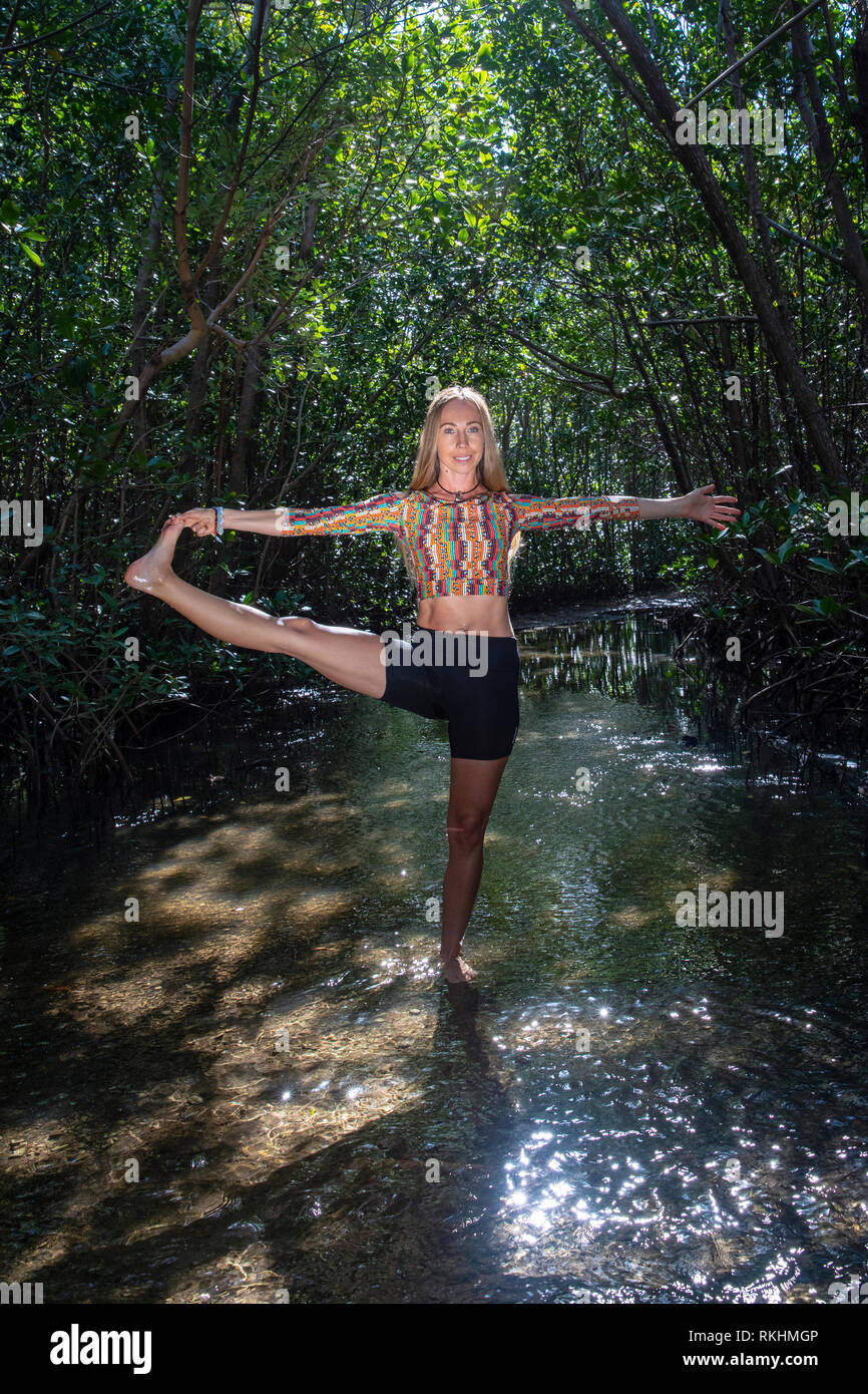 Junge Frau mit Yoga (verlängerte Hand-zu-Big-Toe Pose - Utthita Hasta Padangustasana) in einer natürlichen Umgebung - Fort Lauderdale, Florida, USA Stockfoto