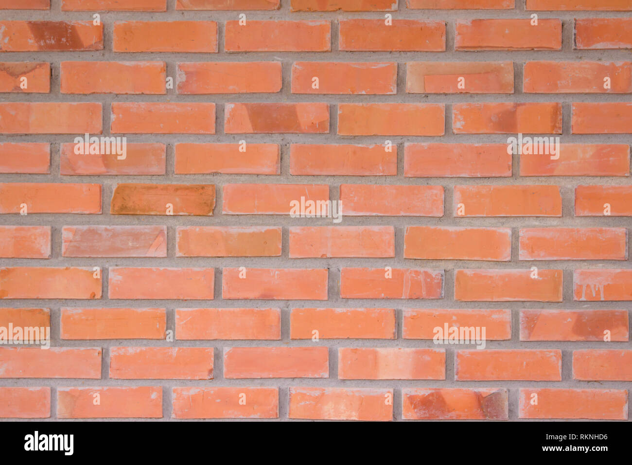 Orange Wand Textur Hintergrund. Mauerwerk oder Mauerwerk Bodenbeläge innen Rock alte Muster sauber konkrete Grid unebener Ziegel Design. Stockfoto