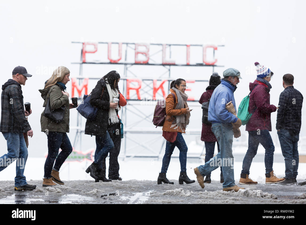 Seattle, Washington: Eine Masse von Besuchern kreuz Pine Street am Pike Place Market als starker Wintersturm decken Seattle in sechs Zentimeter Schnee. Stockfoto