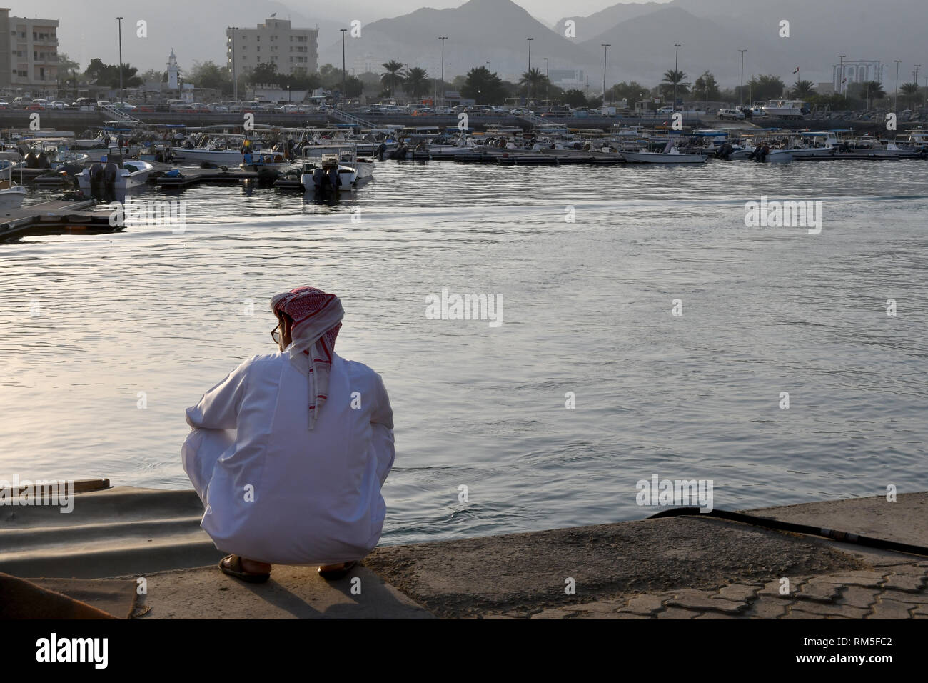 Arabisch Mann sitzt auf seinen hüftknochen am horbour von Khor Fakkan (Sharjah, VAE) Stockfoto