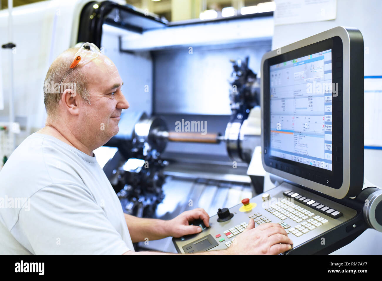 Cnc-Maschine im modernen industriellen Maschinenbau - Arbeitnehmer am Arbeitsplatz Stockfoto