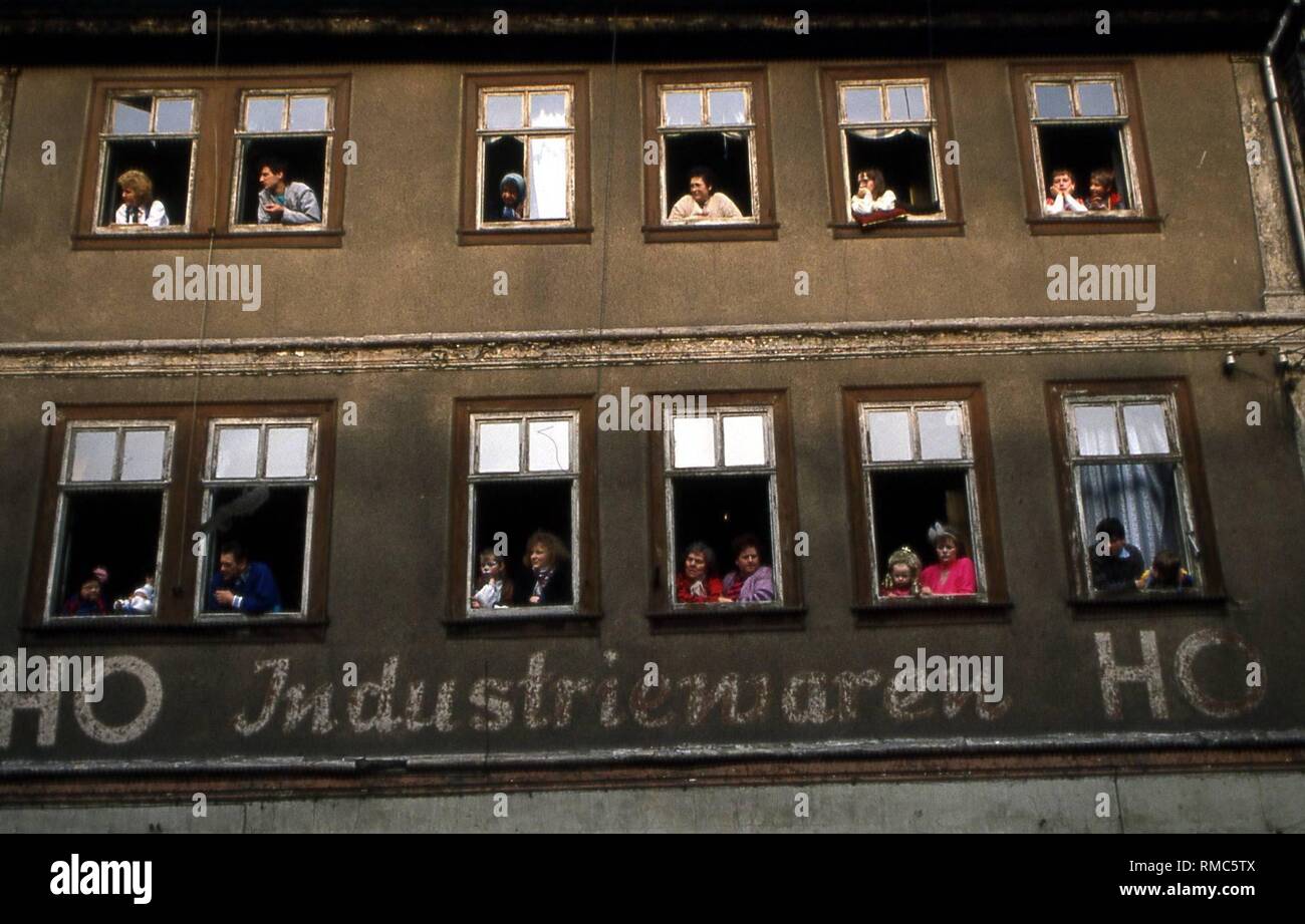 Mitarbeiter beobachten die Karnevalsumzug aus den Fenstern des HO-Industriewaren in Wasungen. Stockfoto