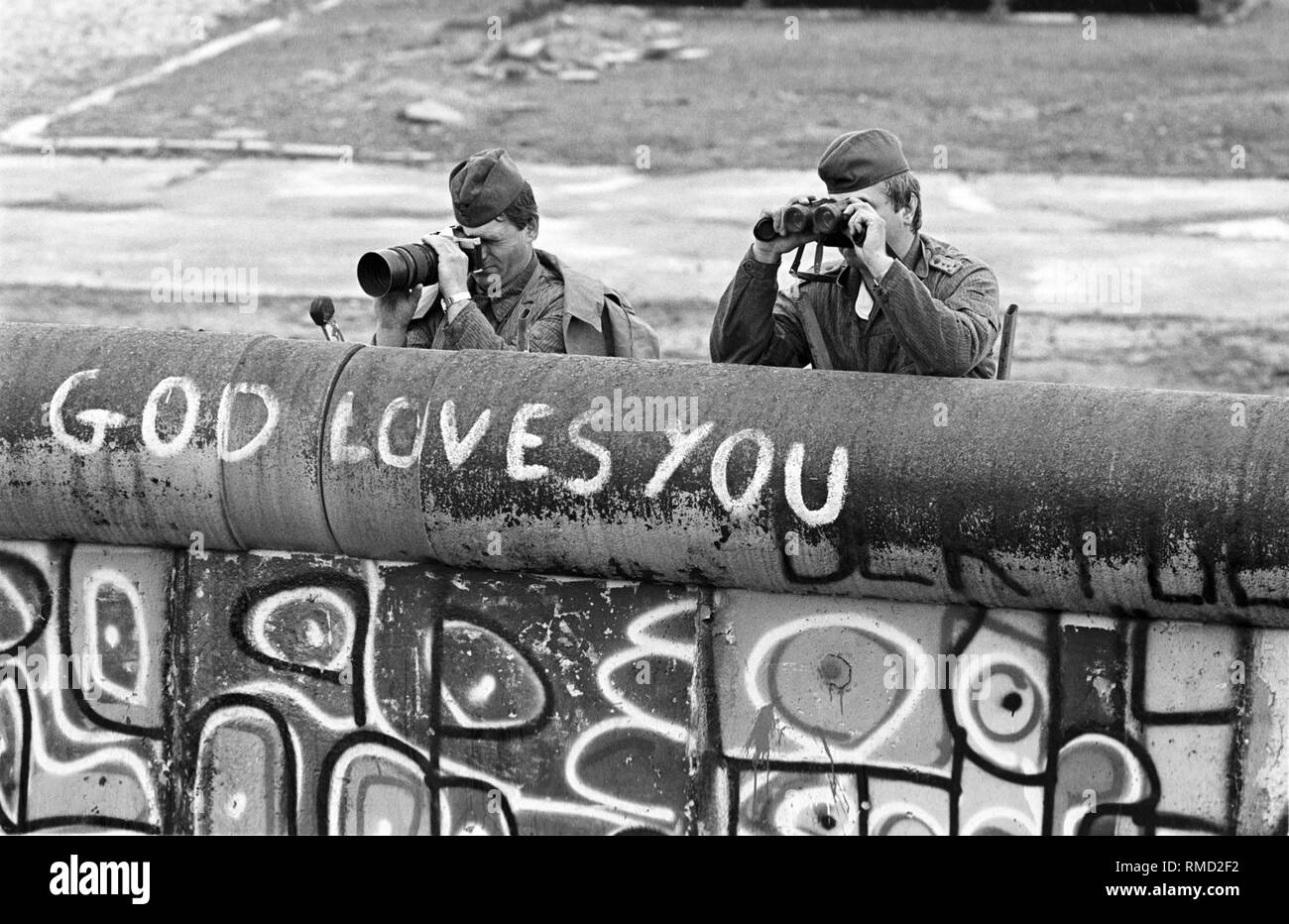 Mitglieder der DDR-Grenztruppen beobachten ein Gas Nutzung durch die West-berliner Polizei gegen die Insassen des sogenannten Lenne Dreieck am Potsdamer Platz. Ende Mai 1988, mehrere hundert Personen besetzt ein Standort in unmittelbarer Nähe der Mauer gegen den Bau einer Autobahn zu protestieren. Als Ergebnis gibt es immer wieder Konflikte mit der Polizei. Stockfoto
