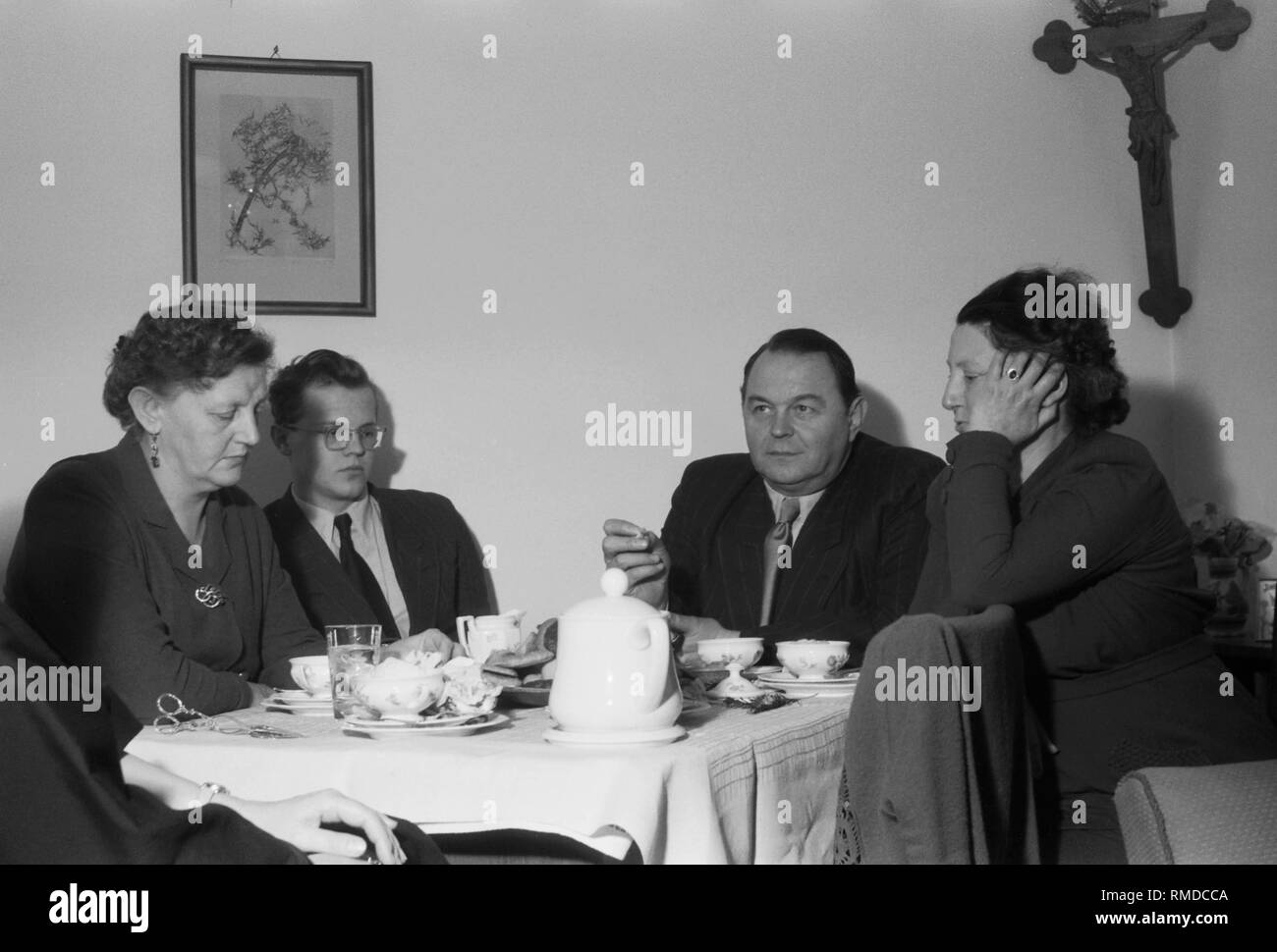 Anzeigen einer Tabelle von Eltern während einer St. Nikolaus Feier in einem Krankenhaus in München, vermutlich der Gynäkologischen Klinik auf Maistrasse. An der Wand ist ein Bild, sowie ein Kruzifix. Stockfoto