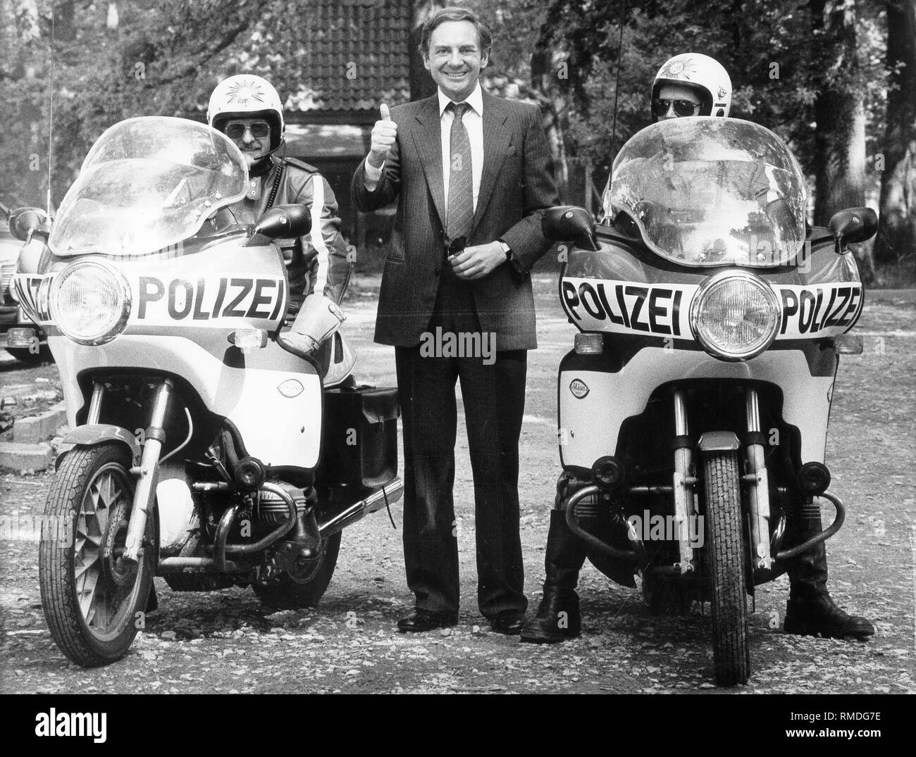 Harald Juhnke zwischen zwei Polizisten auf Motorrädern. Stockfoto