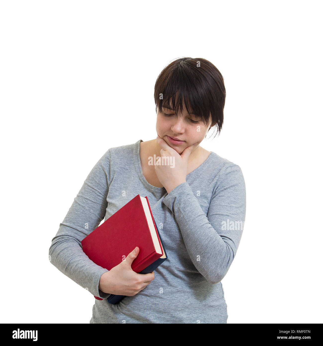 Verärgert nachdenklich Studentin, eine Hand unter das Kinn, auf weißem Hintergrund denken. Stockfoto