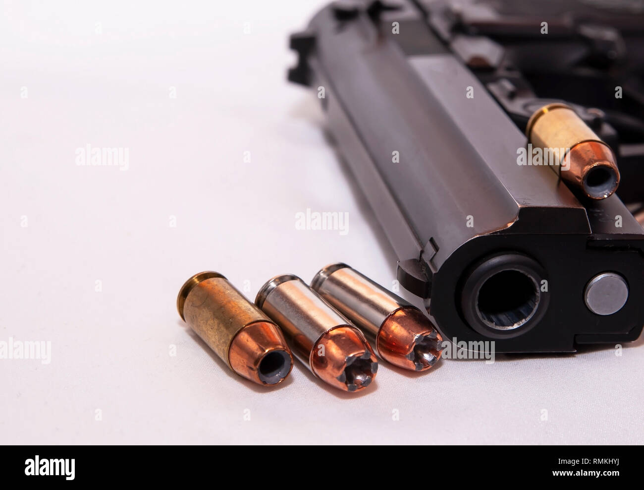 Eine schwarze 40 Kaliber Pistole mit vier 40 Kaliber hollow point Kugeln auf weißem Hintergrund Stockfoto