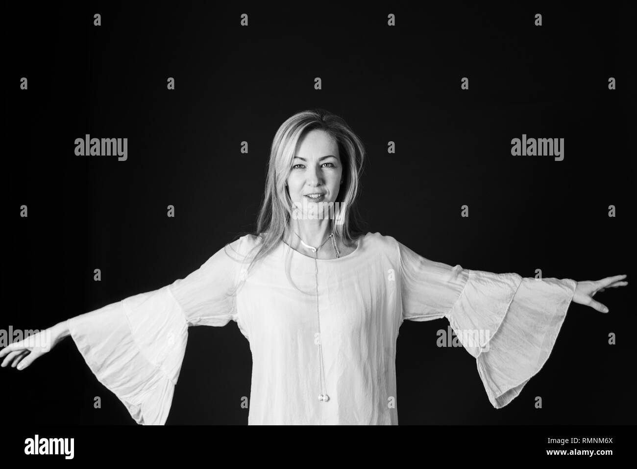 In der Nähe von Studio Portrait einer schönen Frau im weißen Kleid auf schwarzem Hintergrund Stockfoto