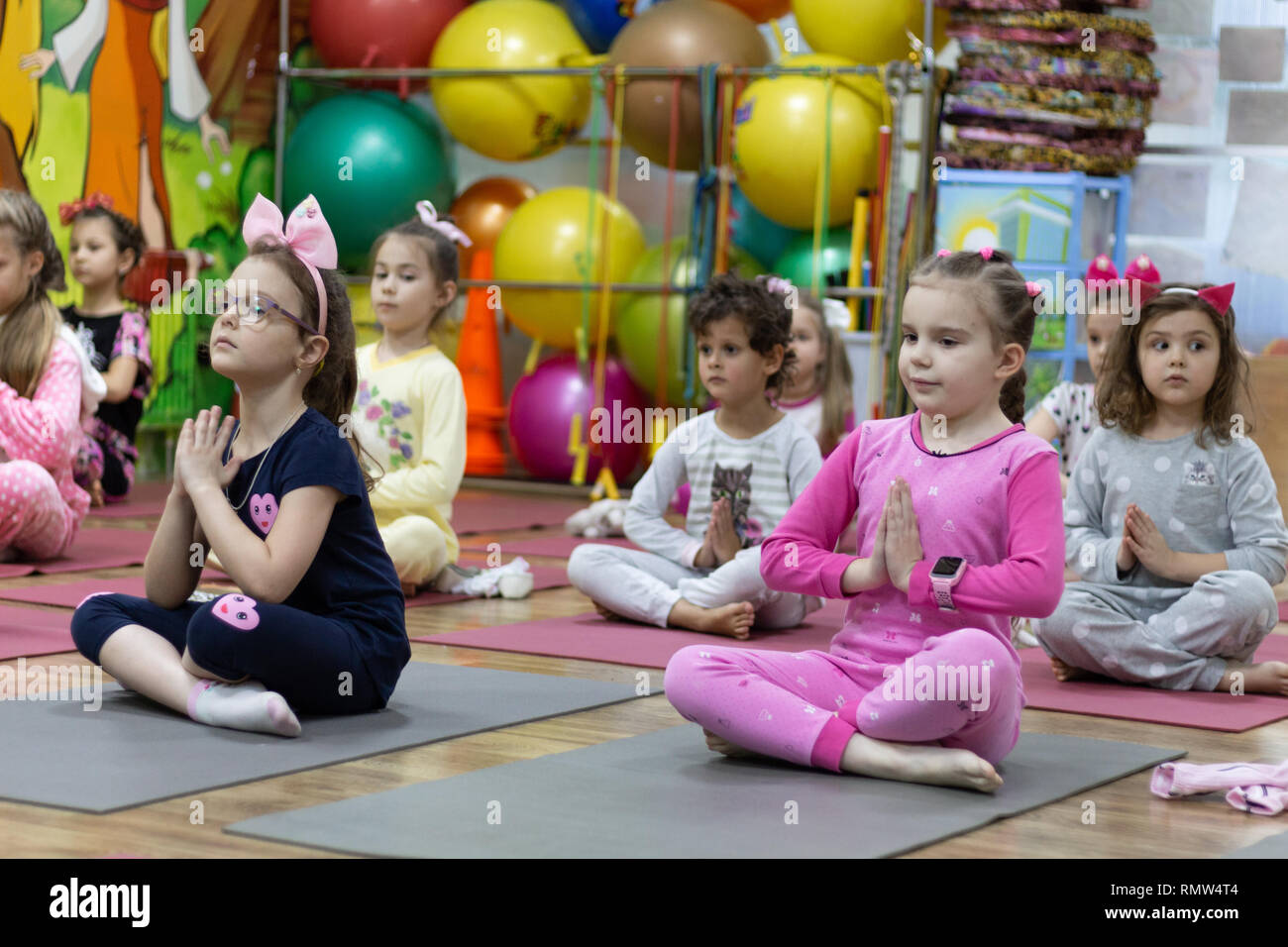 Kinder Yoga im Schlafanzug mit einem professionellen Lehrer. Stockfoto