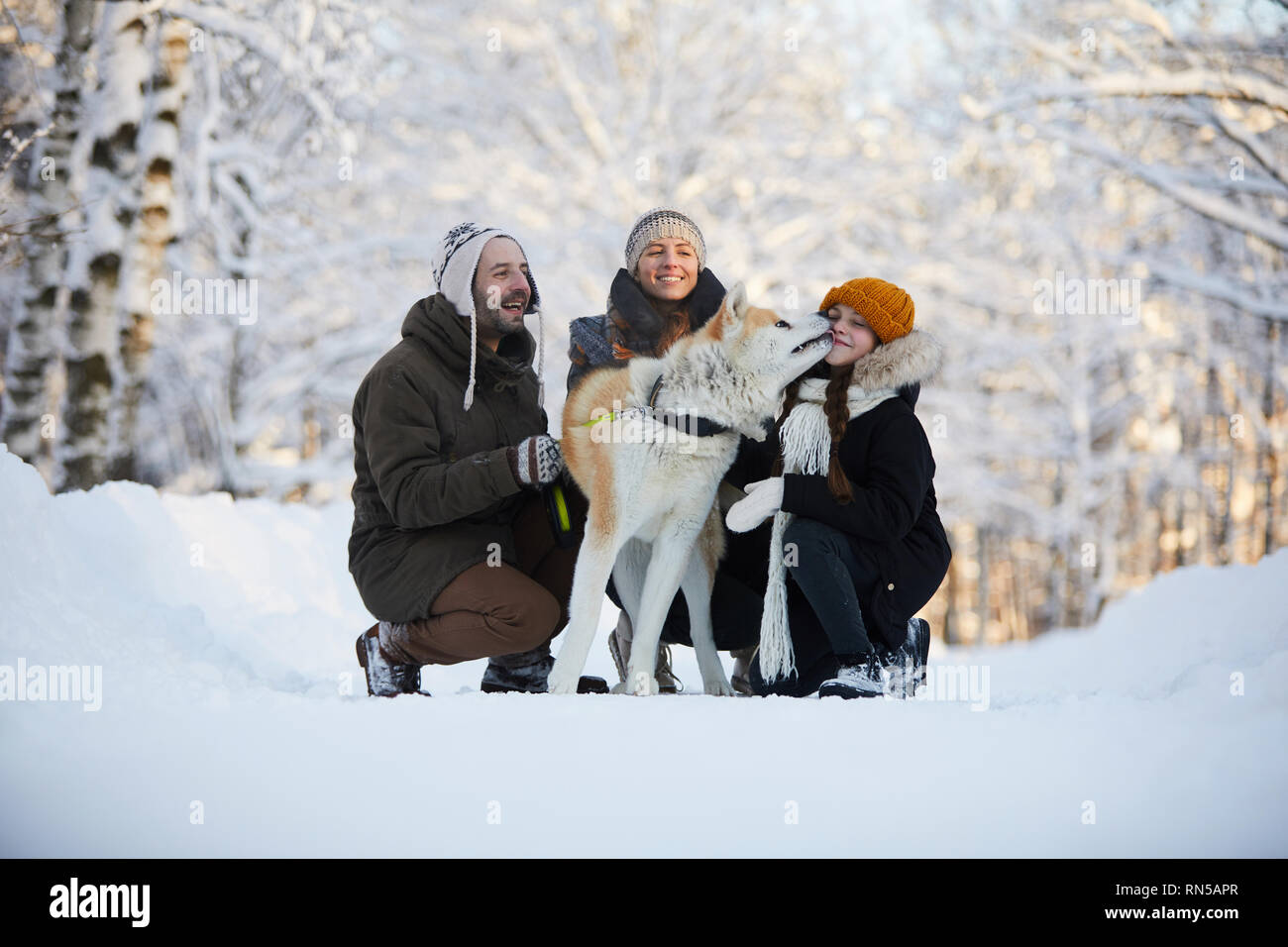 Glückliche Familie mit Hund im Freien Stockfoto
