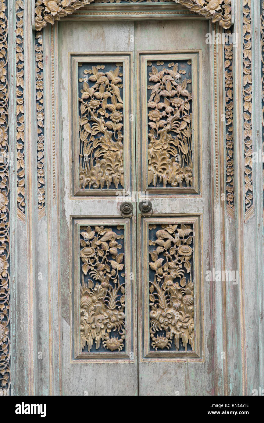 Balinesischen holzgeschnitzten Türen mit traditionellen Ornamenten. Lokale Traditionen und Handwerk Konzept Stockfoto