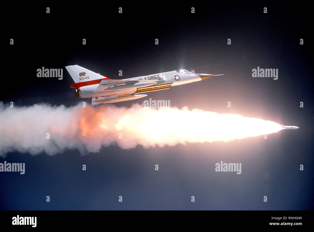 1980 - Ein Luft-zu-Luft, rechts eine F-106 Delta Dart Flugzeuge nach dem Feuern eine ATR-2 eine Rakete über einen Bereich. Einen Hilfskraftstofftank ist auf jedem Flügel Stockfoto