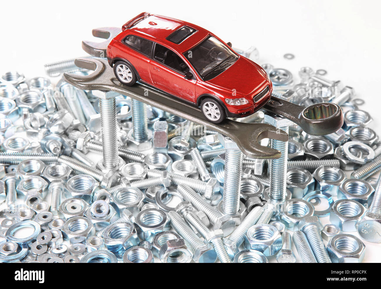 Rote Spielzeugauto auf Schlüssel Schrauben und Muttern Stockfoto
