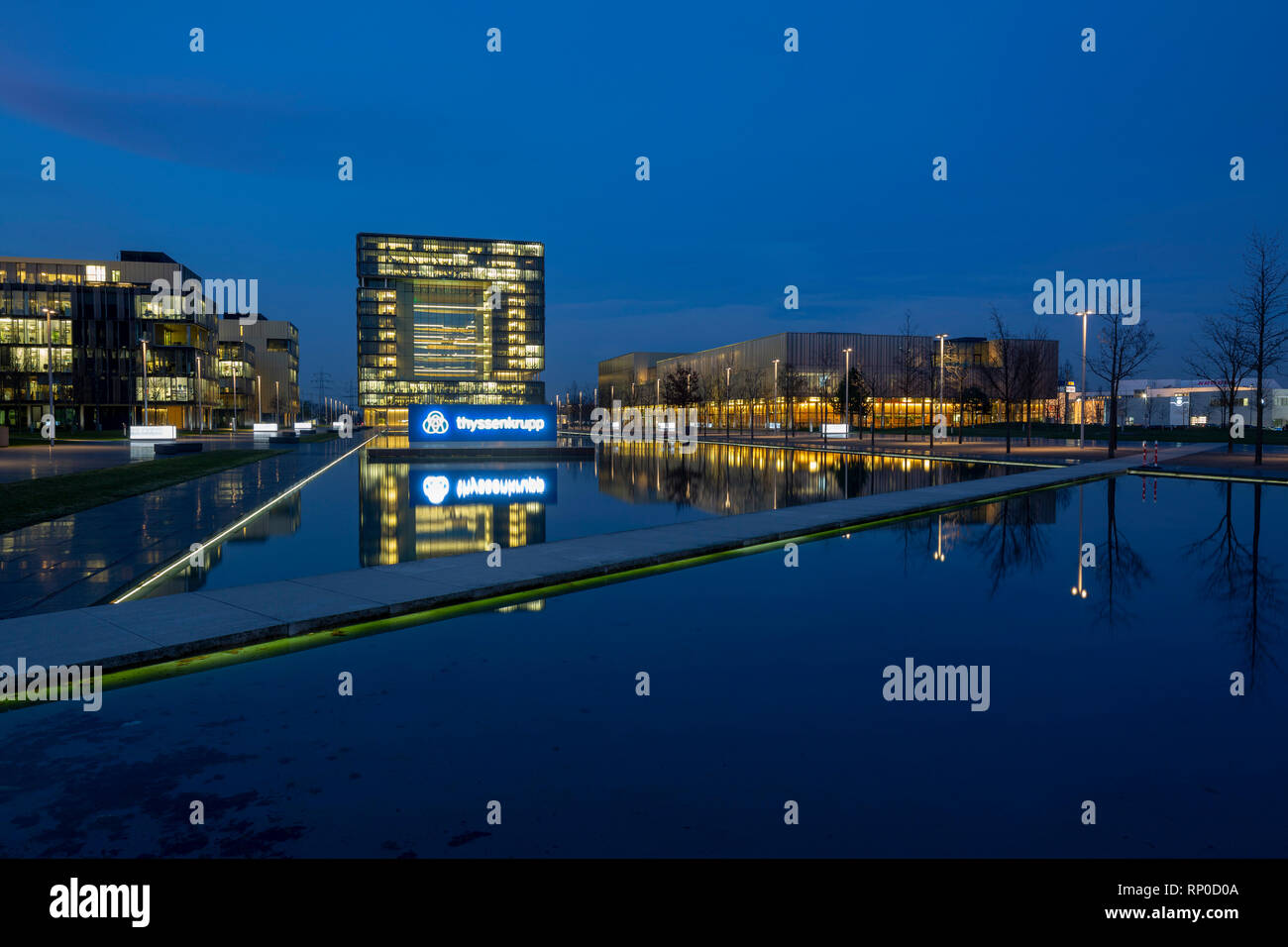 D-Essen, Ruhrgebiet, Rheinland, Nordrhein-Westfalen, NRW, D-Essen-Altendorf, Thyssenkrupp AG, der ehemaligen Thyssen AG und Friedrich Krupp AG Hoesch Krupp, Hauptquartier, Industrieunternehmen, Stahlerzeugung, Stahlbearbeitung, Edelstahl, Anlagenbau, Aufzüge, Werften, Logo, Firmenlogo, Abend, Blaue Stunde, Beleuchtung, Wasserbecken, Spiegelung, Route der Industriekultur Stockfoto