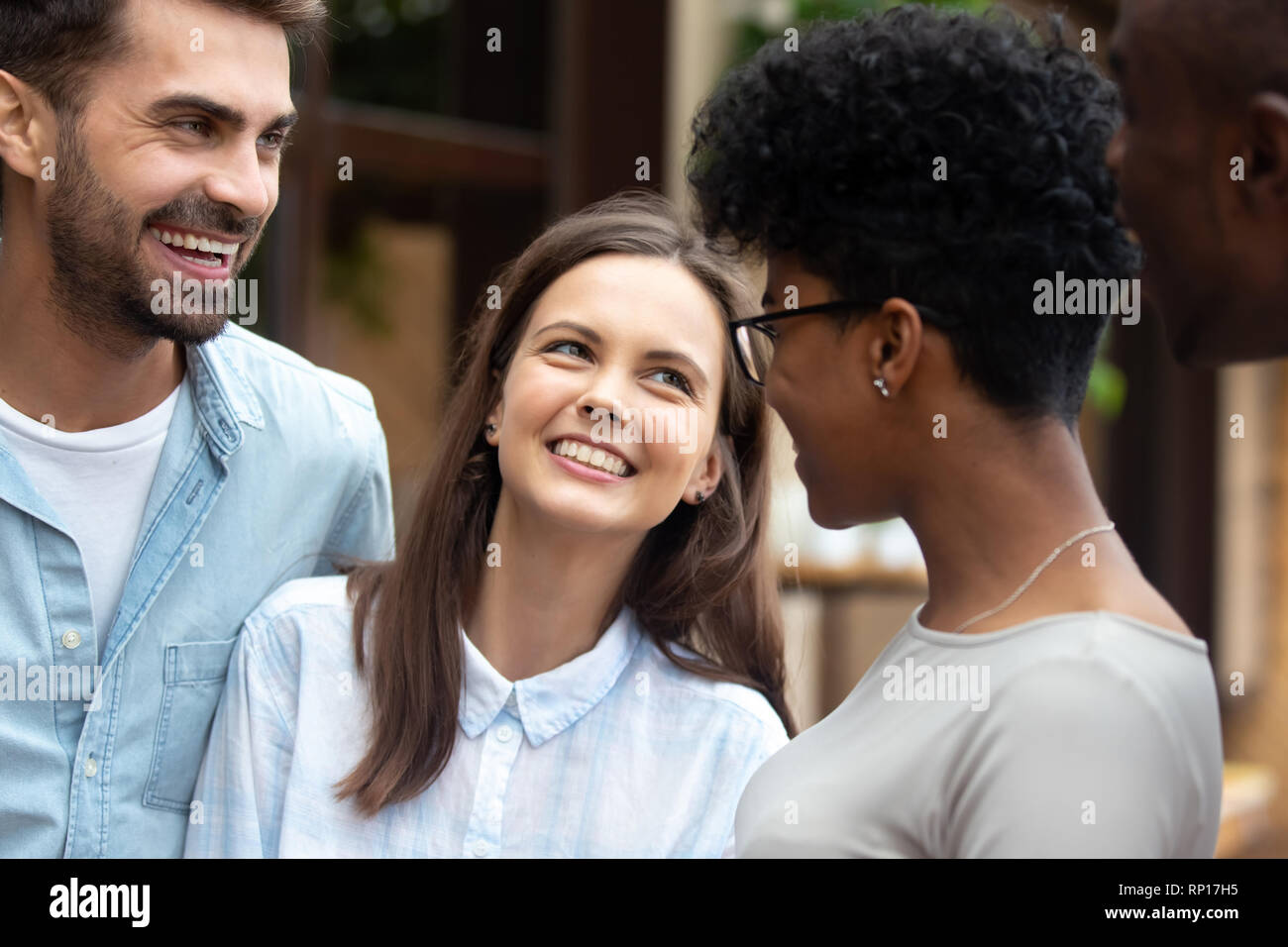 Diverse Freunde Mädchen und Jungs stehen lachend im Freien Stockfoto