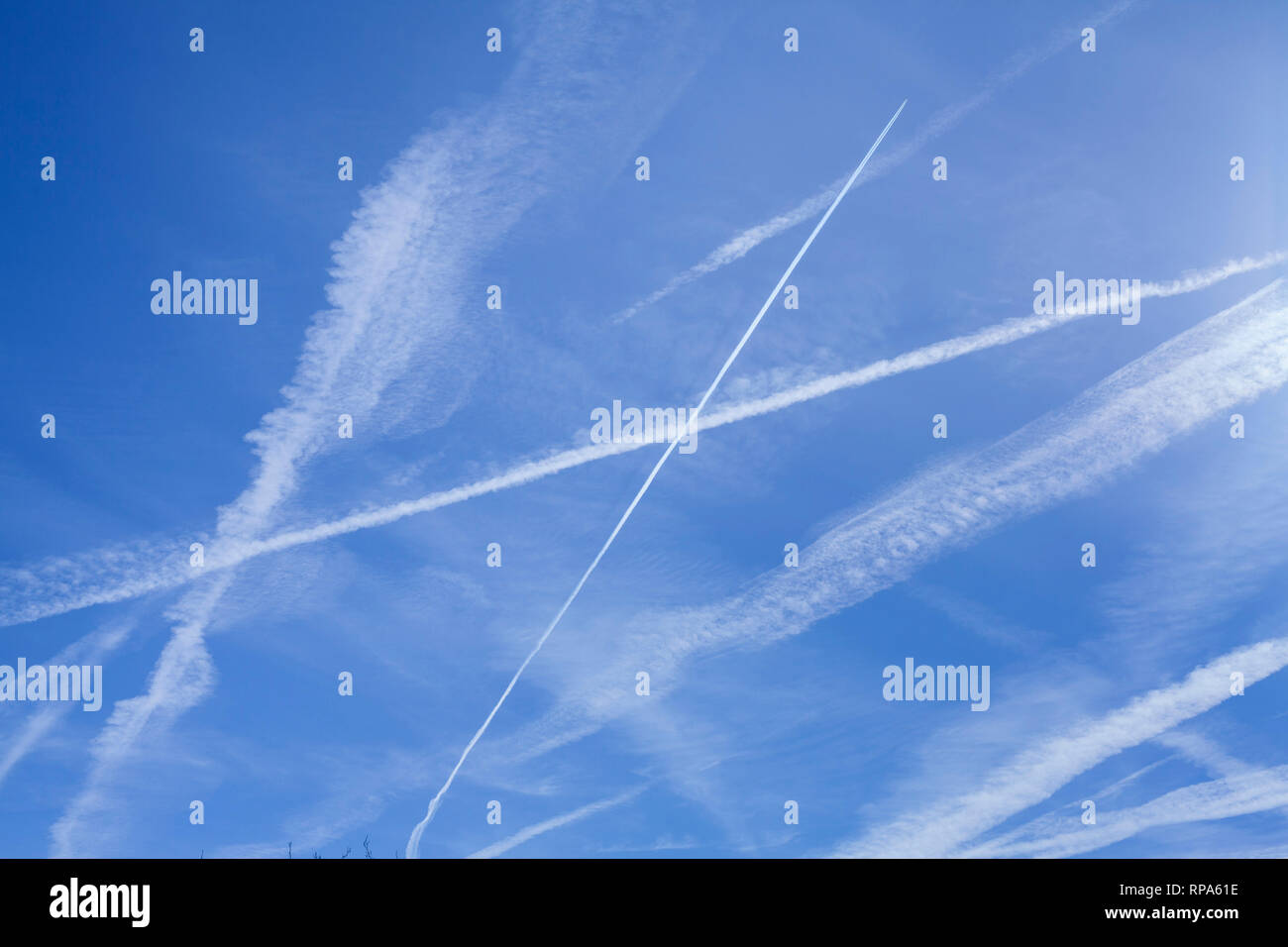 Abstrakte Muster von Kondensstreifen in den blauen Himmel, die manchmal als kondensstreifen oder Kondensstreifen bekannt. Stockfoto