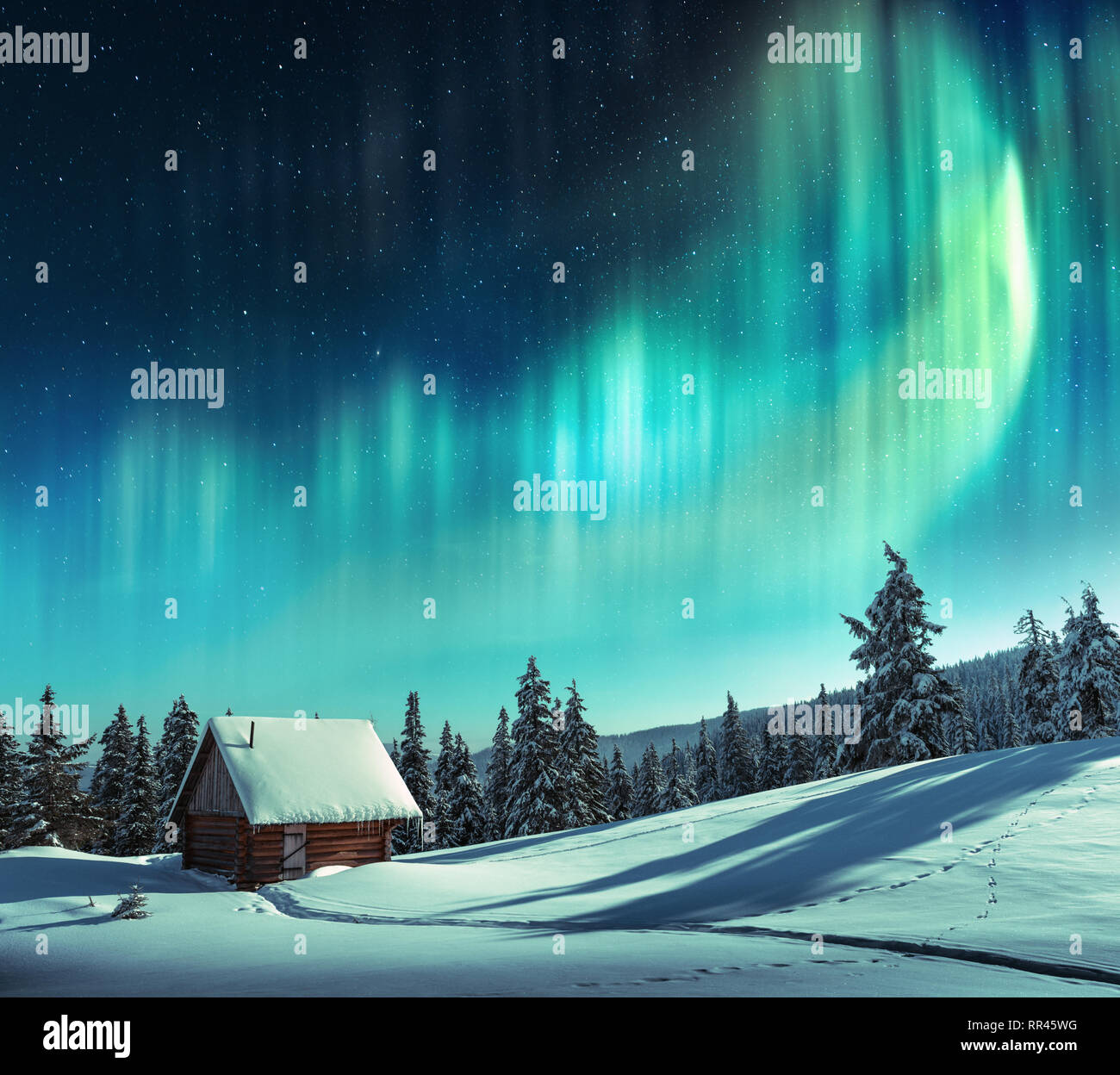 Fantastische Winterlandschaft mit Holz- Haus in Snowy Mountains und nordische Licht in den Nachthimmel Stockfoto