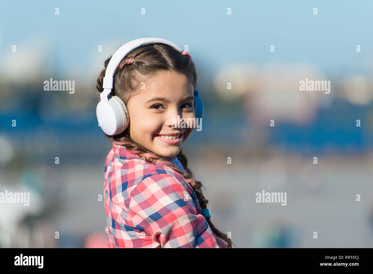 Musik gibt ihr große Freude. Niedliche Kind mit Wireless Headset. Kleines Kind tragen Stereo Kopfhörer. Kleines Kind Musik zu hören. Adorable Kind mit Technologie für Freizeit oder Bildung. Stockfoto