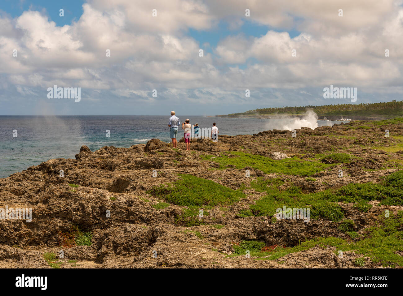 Küste, Tonga - - März 10, 2018. Eine Gruppe von Touristen steht auf einer Klippe an der Küste und beobachtet Blowholes schießt das Wasser in den Himmel. Stockfoto