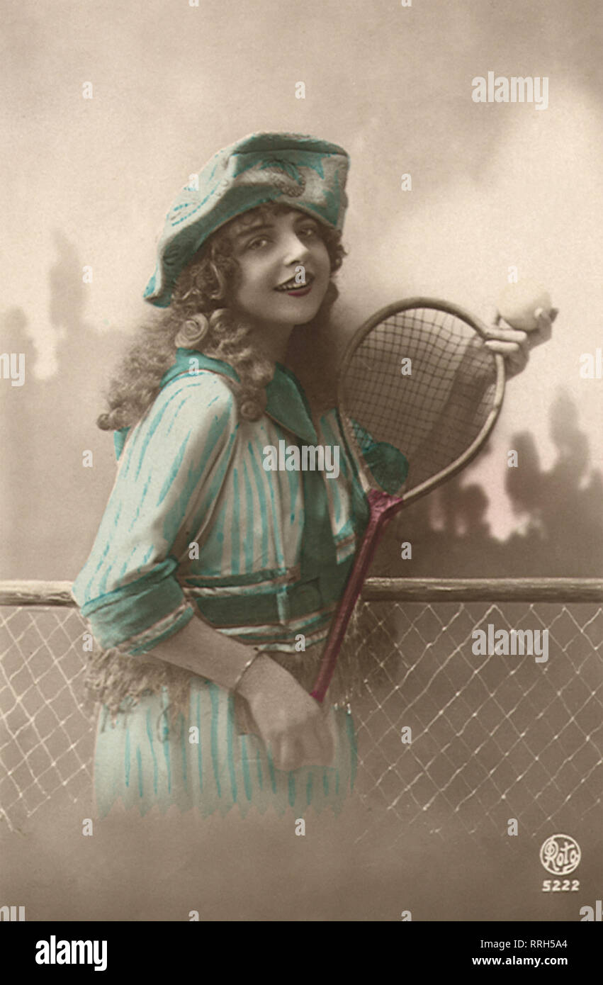 Frau im blauen Kleid mit Tennisschläger und Ball. Stockfoto