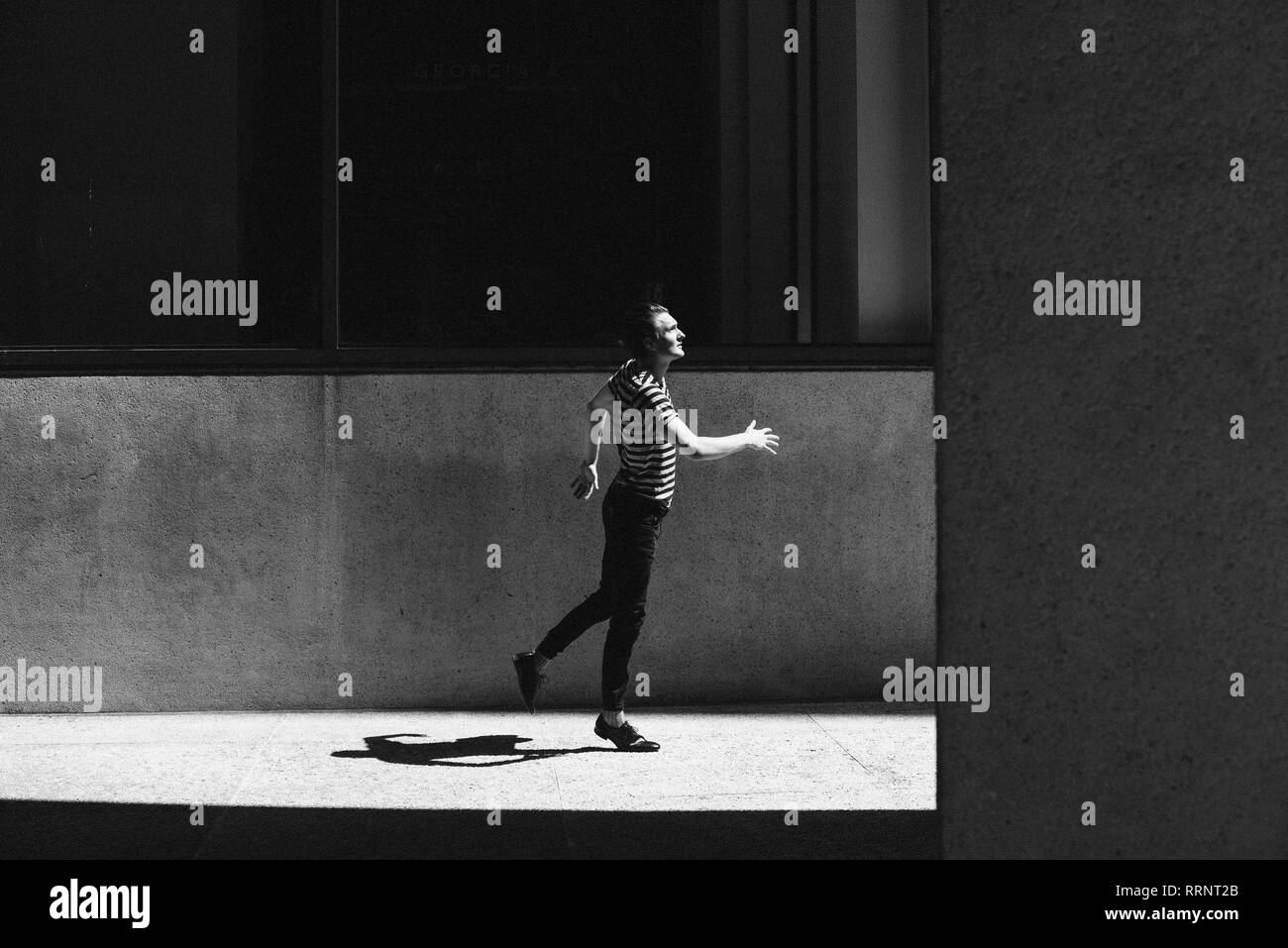 Junge Männer treten auf städtischen Gehsteig Stockfoto