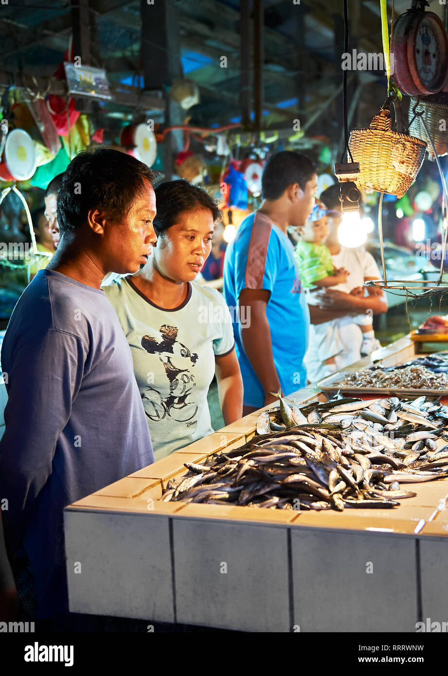 Brookes Point, Palawan, Philippinen - 9. März 2011: eine philippinische Mitte Alter Paar an viele kleine Fische innerhalb des öffentlichen Wet Market suchen Stockfoto