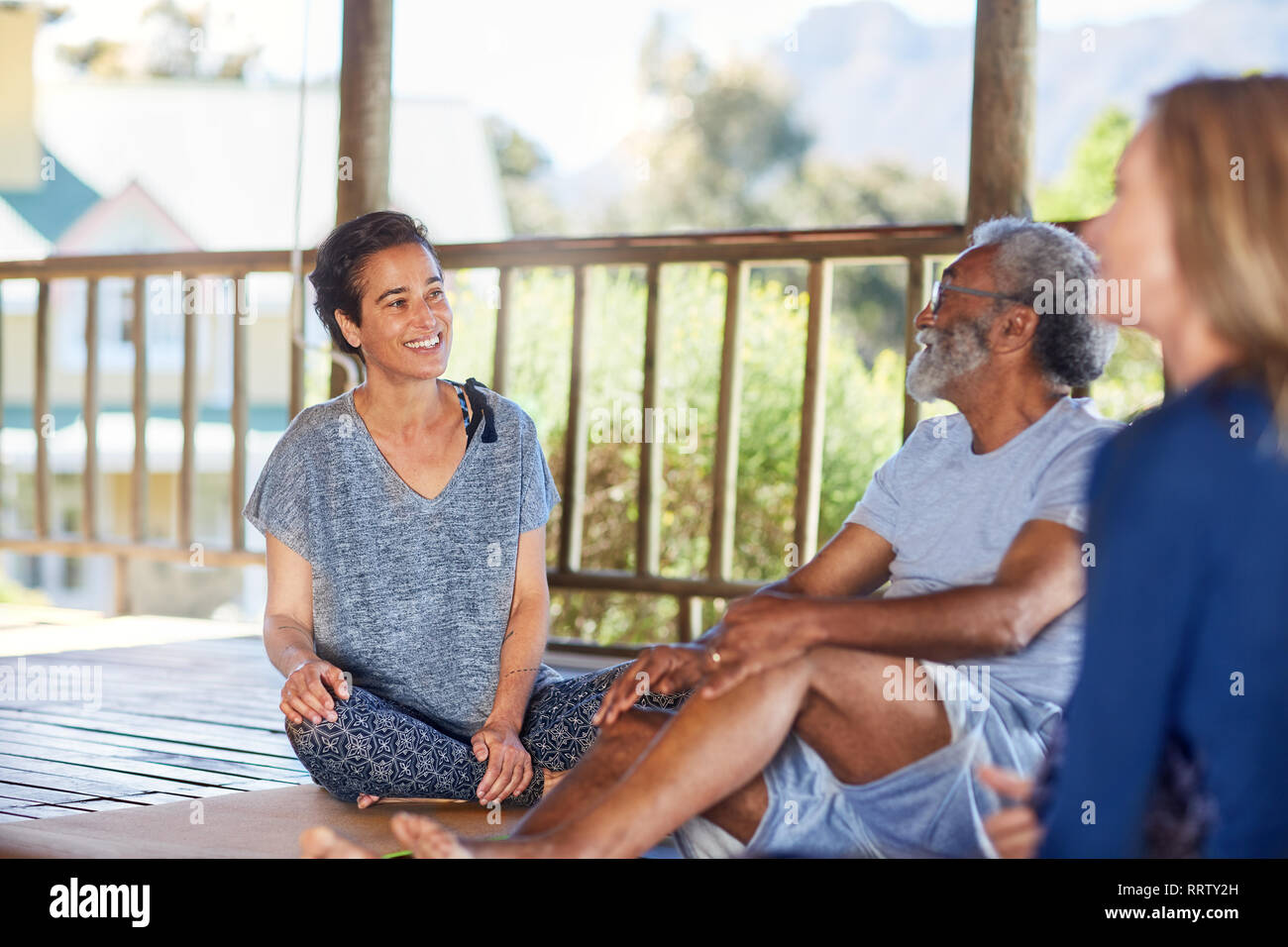 Lächelnd Mann und Frau sprechen in der Hütte während Yoga Retreat Stockfoto