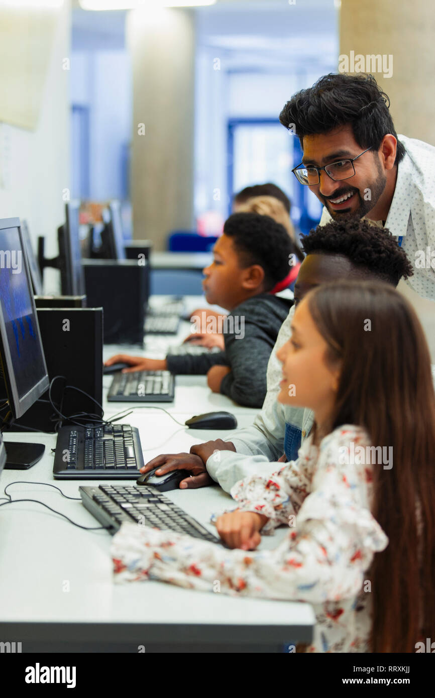 Lehrer helfen Junior high Schüler mit Computer im Computer Lab Stockfoto