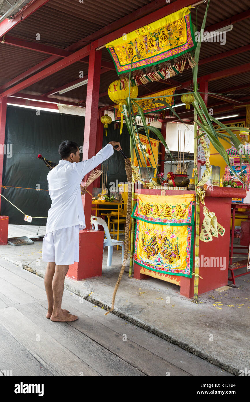 George Town, Penang, Malaysia. Priester führt Ritual aufschnappen Seil am Heiligtum vor Kang Thean Kong (Tempel des Gottes Segen), Kauen Jetty. Stockfoto