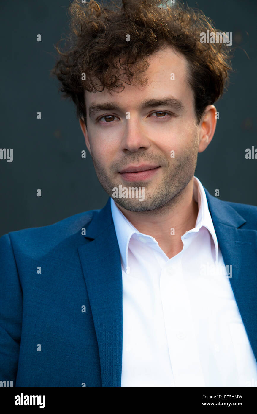 Portrait von lächelnden Geschäftsmann mit Stoppeln und Lockige braune Haare Stockfoto