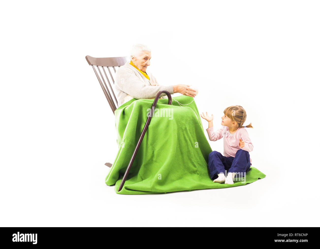 Alte Frau saß auf dem Schaukelstuhl mit ihren Enkelkindern Stockfoto