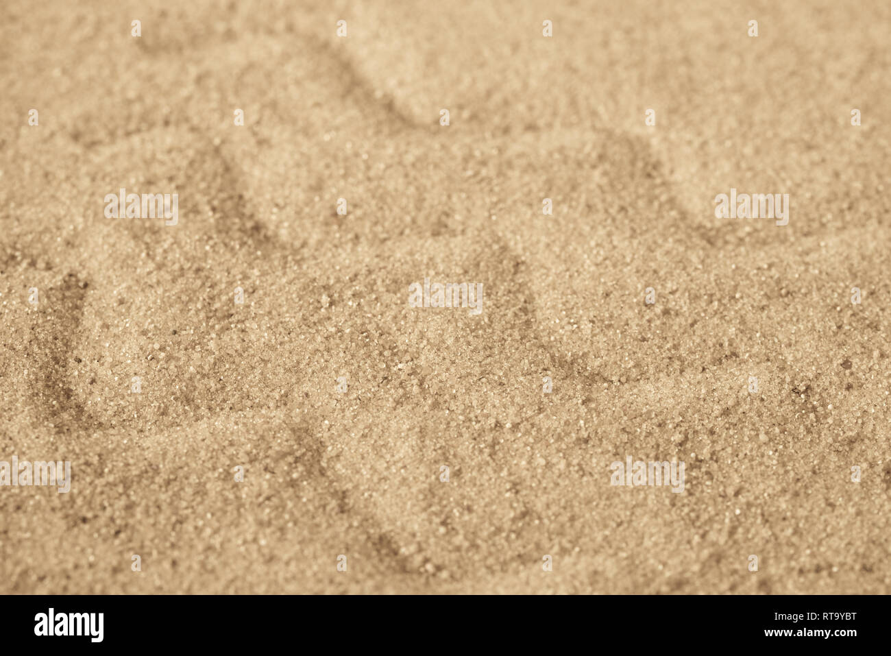 Wellenmuster auf Sand Hintergrund Textur Makro Stockfoto