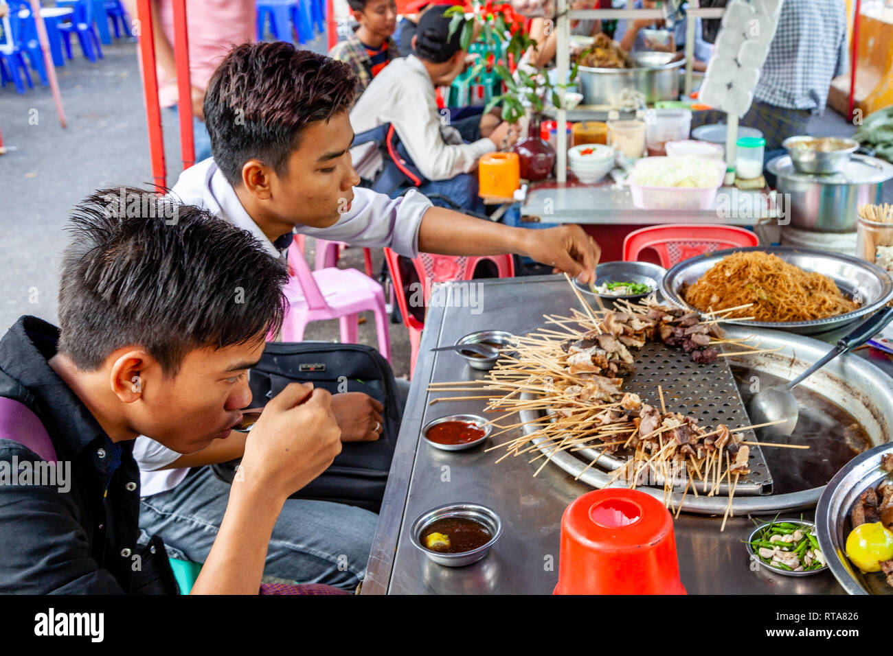 Zwei Jungen im Teenageralter Essen Street Food, Yangon, Myanmar Stockfoto