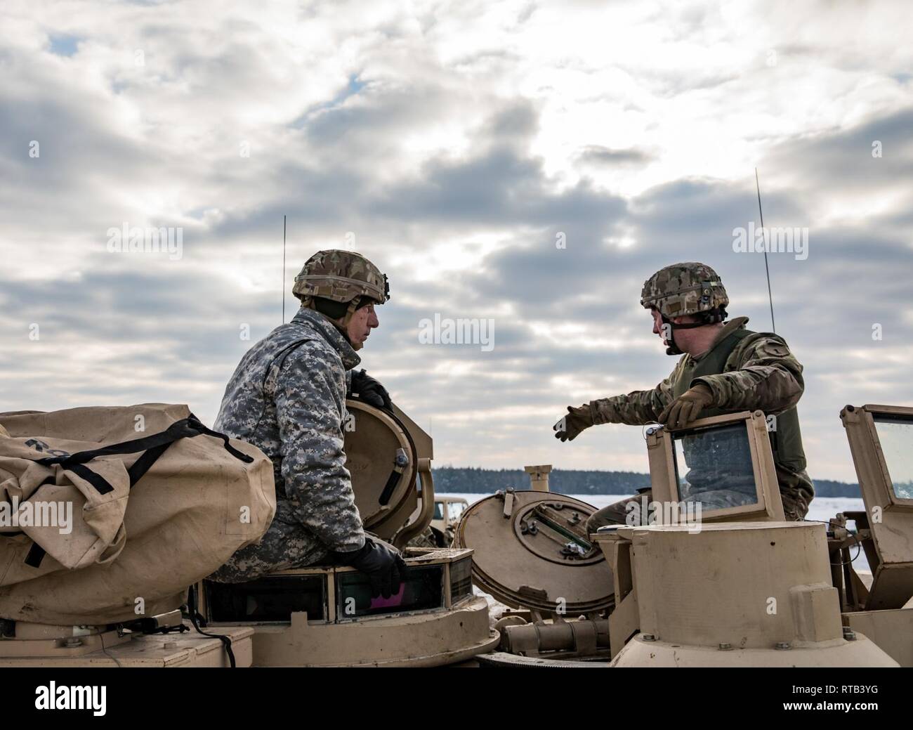 ŚWIĘTOSZÓW, Polen (Feb. 6, 2019) - Sgt. Michael Messersmith, ein M1 Abrams Tank Gunner mit der 1. Staffel, 4 U.S. Cavalry Regiment aus Fort Riley, Kan., erläutert die Funktionen des M1 Abrams Tank zu Vincent "B.J." Lawrence, der Oberbefehlshaber der Kriegsveteranen der USA, vor einem live-fire Übung an einem Schießplatz in der Nähe von Świętoszów. Als Kommandant der VFW, Lawrence persönlich die Soldaten der 1-4 Kavallerie besucht, als in einer Bemühung, besser die Ausbildung Umwelt verstehen mobilisiert und die Lebensbedingungen der Truppen in Übersee, in Unterstützung der O stationiert Stockfoto