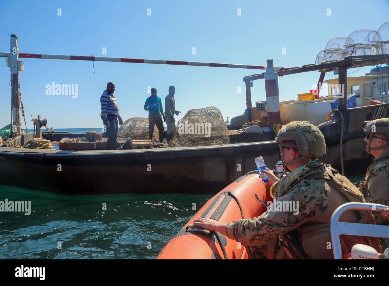 ARABIAN GULF (Feb. 07, 2019) der U.S. Coast Guard Maschinen Techniker 2. Klasse Jon Christiansen, zur Insel zugeordnet - Klasse Patrouillenboot USCGC Maui (WPB 1304) bereitet zu werfen liefert an Bord eines Angeln Dhow während des Besuchs, Board, Suche zu Fischer, und Beschlagnahme. Maui ist Vorwärts - in die USA 5 Flotte Bereich der Maßnahmen zur Unterstützung der Marine im Einsatz für die Stabilität und Sicherheit in der Region zu gewährleisten und verbindet das Mittelmeer und den Pazifischen Raum durch den westlichen Indischen Ozean und drei strategischen Punkten ersticken. Stockfoto