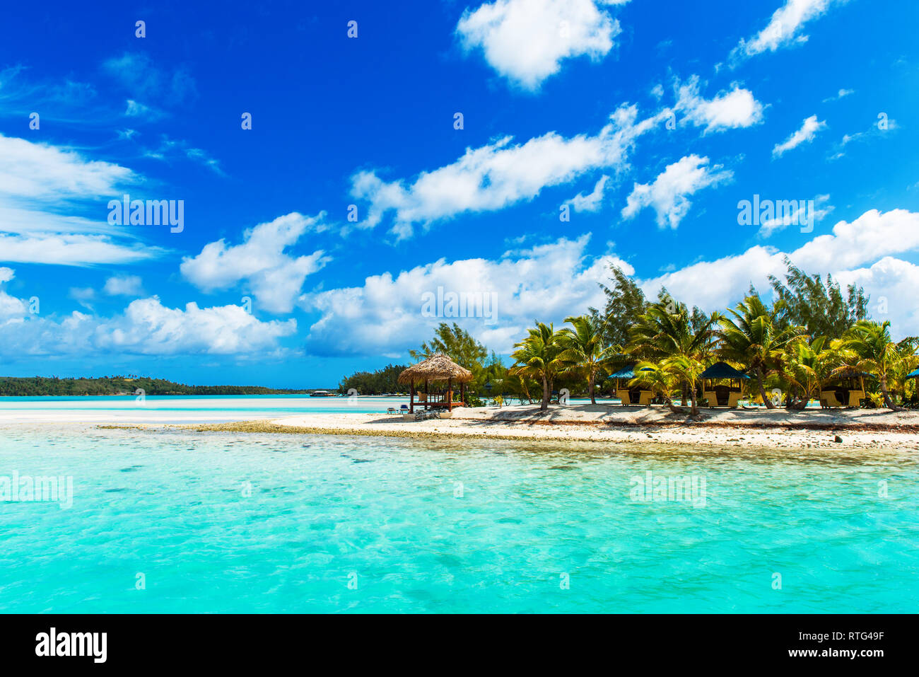 Atemberaubende tropische Aitutaki Insel mit Palmen, weißer Sand, türkises Meer Wasser und blauem Himmel in der Cook Inseln, Südpazifik. Kopieren Sie Platz für Text Stockfoto