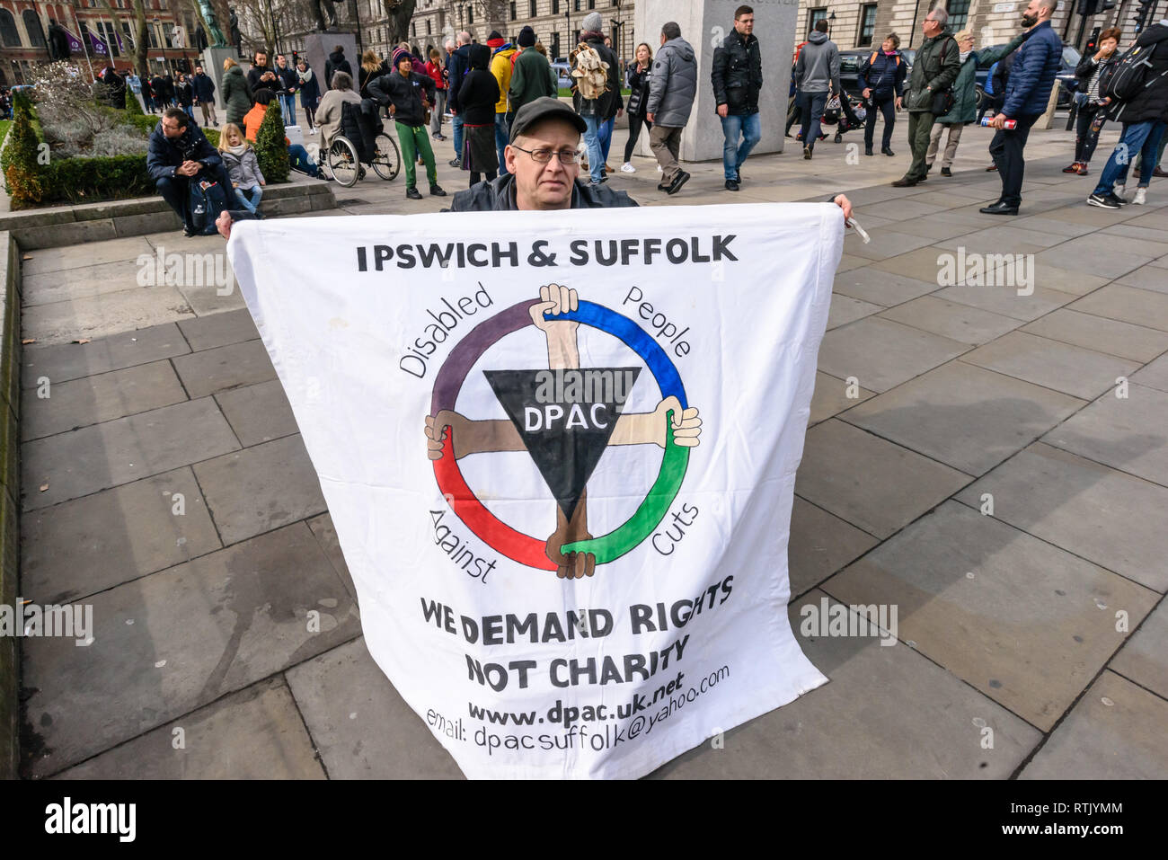 London, Großbritannien. 1. März, 2019. Demonstranten in Parliament Square, darunter zwei in den Rollstühlen, fordern Ende der Universal Credit, die weit verbreitete Armut und extremer Armut. Ein kleiner Grabstein aufgezeichnet, um die 12,980 Todesfälle innerhalb von sechs Wochen nach der gefunden werden fit für die Arbeit und die 120.000 frühzeitige Todesfälle von der Tory Kürzungen seit 2010. Credit: Peter Marschall/Alamy leben Nachrichten Stockfoto