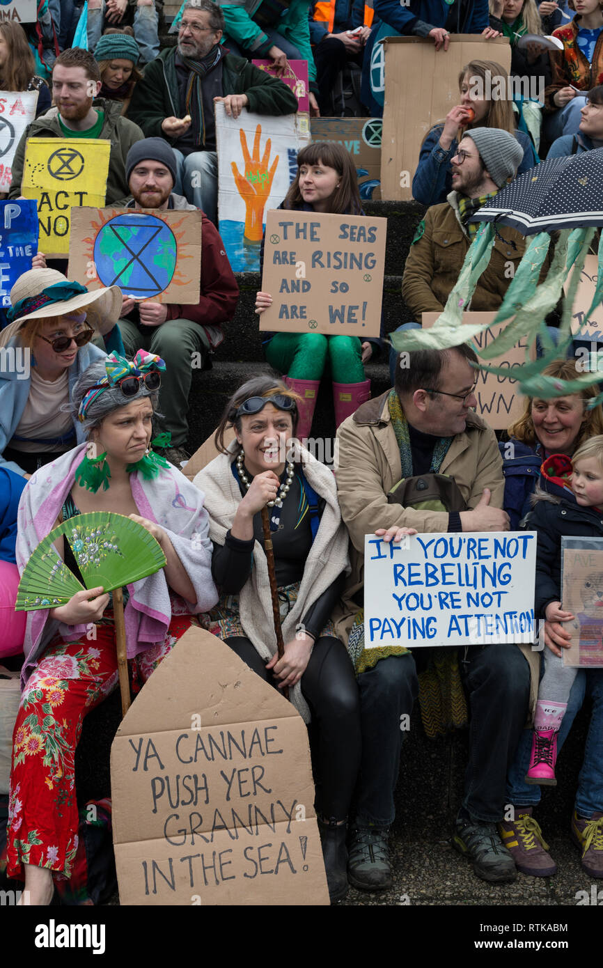 Glasgow, Schottland, 2. März 2019. Das "Blue Wave" Demonstration vom Aussterben Rebellion Klimawandel Gruppe und Unterstützer, blockieren Straßen und bewegen sich durch die Straßen der Stadt das steigende Wasser des Flusses Clyde zu markieren und auf die Gefahren des Klimawandels zu warnen, wenn dringende Maßnahmen nicht sofort ergriffen werden. Die friedliche Demonstration von ca. 200 Menschen kulminierte mit dem symbolischen Werfen von Wasser aus dem Fluss Clyde auf die Stadt schritte Kammern, ein Symbol für die Wasserstände zu kommen. In Glasgow, Schottland. Quelle: Jeremy Sutton-Hibbert / alamy Leben Nachrichten. Stockfoto