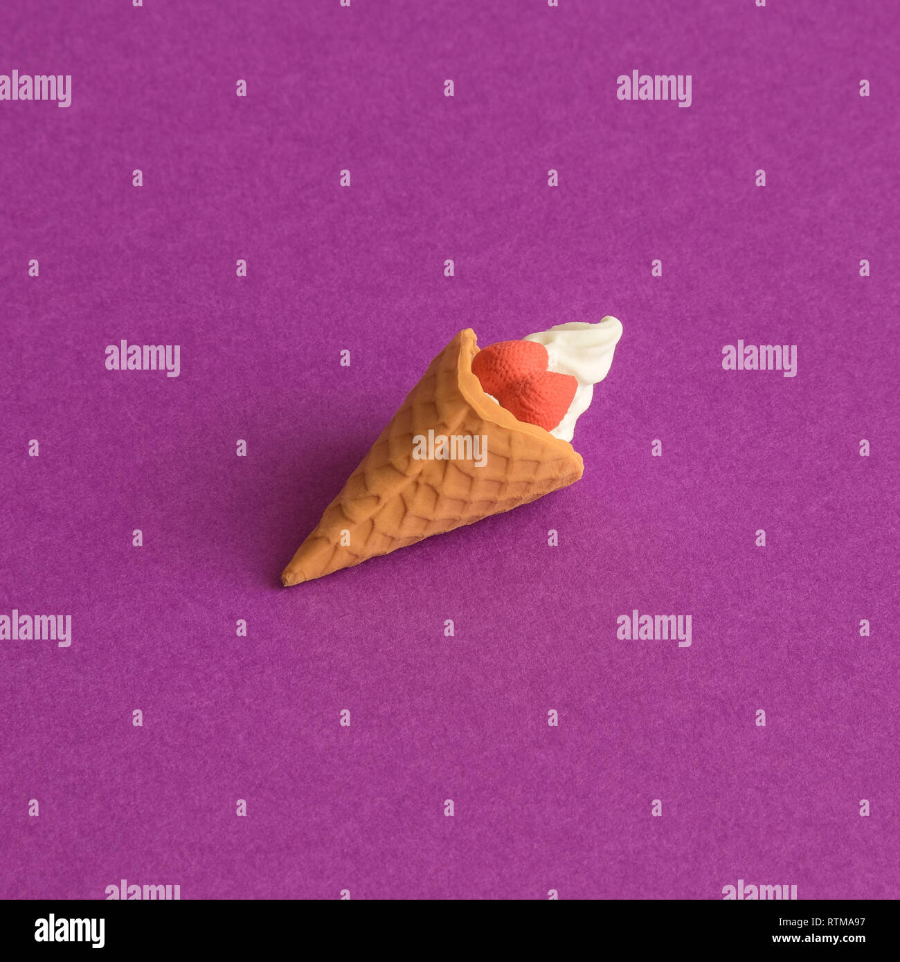 Kleine Eis Spielzeug abstract am violetten Hintergrund Sommer und süßen Speisen. Stockfoto