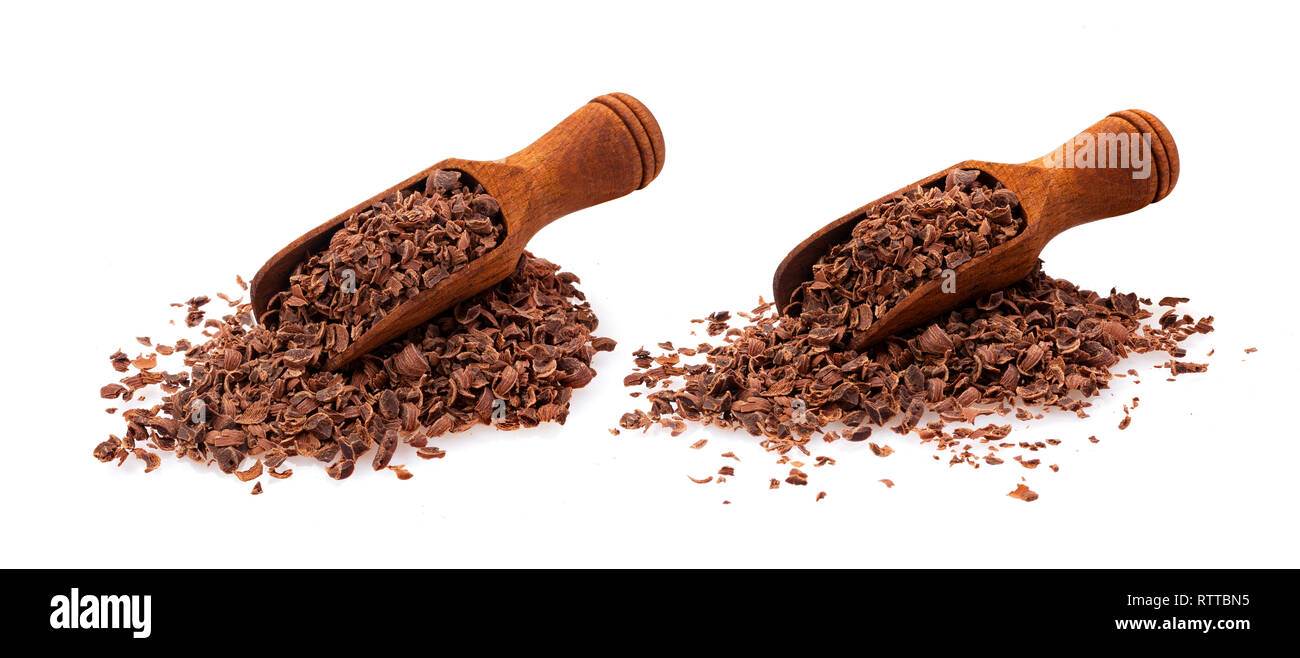 Geriebener Schokolade. Stapel der Boden Schokolade in Holz- Schaufel auf weißem Hintergrund, Nahaufnahme Stockfoto