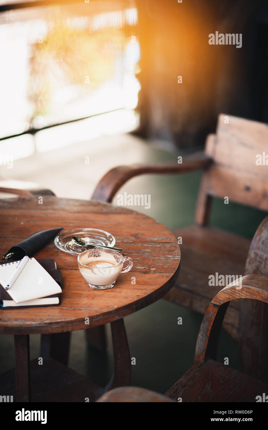 Abstrakte Szene der Kaffeetasse und Notebooks auf rustikalen Holztisch. Kaffeepause und Zeit entspannen. Arbeiten von überall. Stockfoto