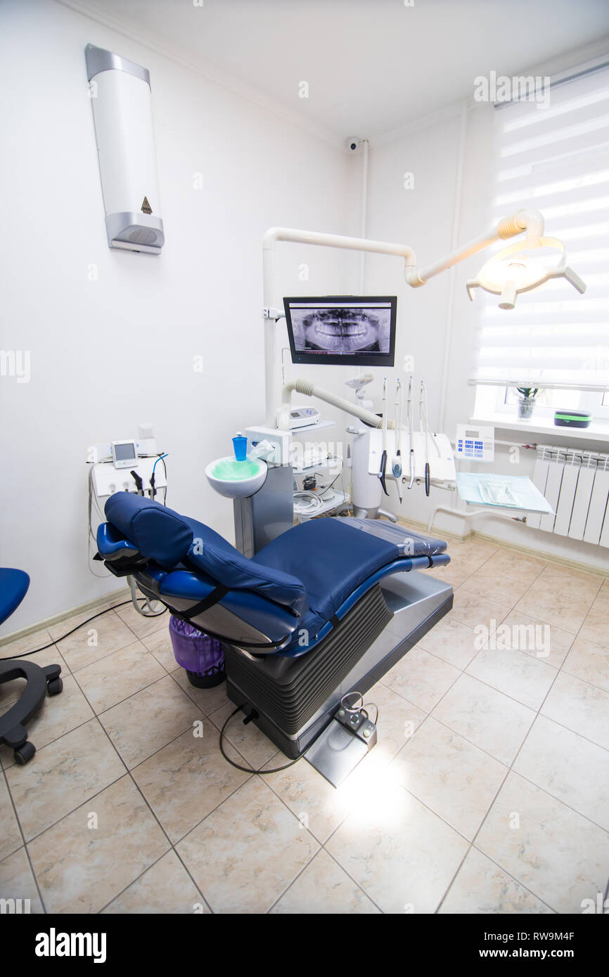 Moderne zahnmedizinische Praxis. Behandlungsstuhl und anderes Zubehör von den Zahnärzten in Blau Stockfoto