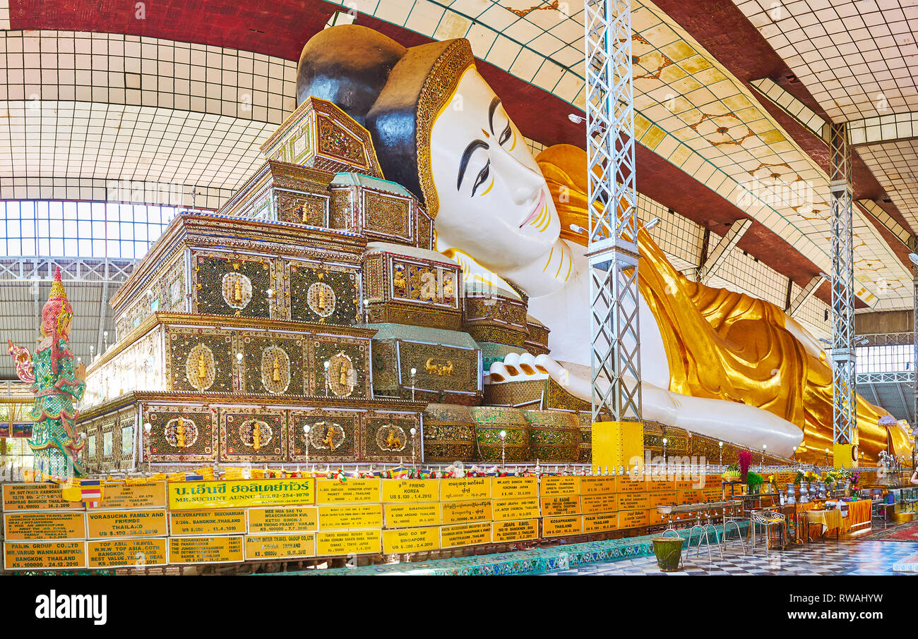 BAGO, MYANMAR - Februar 15, 2018: das Innere der Shwethalyaung Buddha Tempel, mit grossen Buddha Statue, liegen auf dem malerischen Mosaic Kissen dekoriert, wit Stockfoto