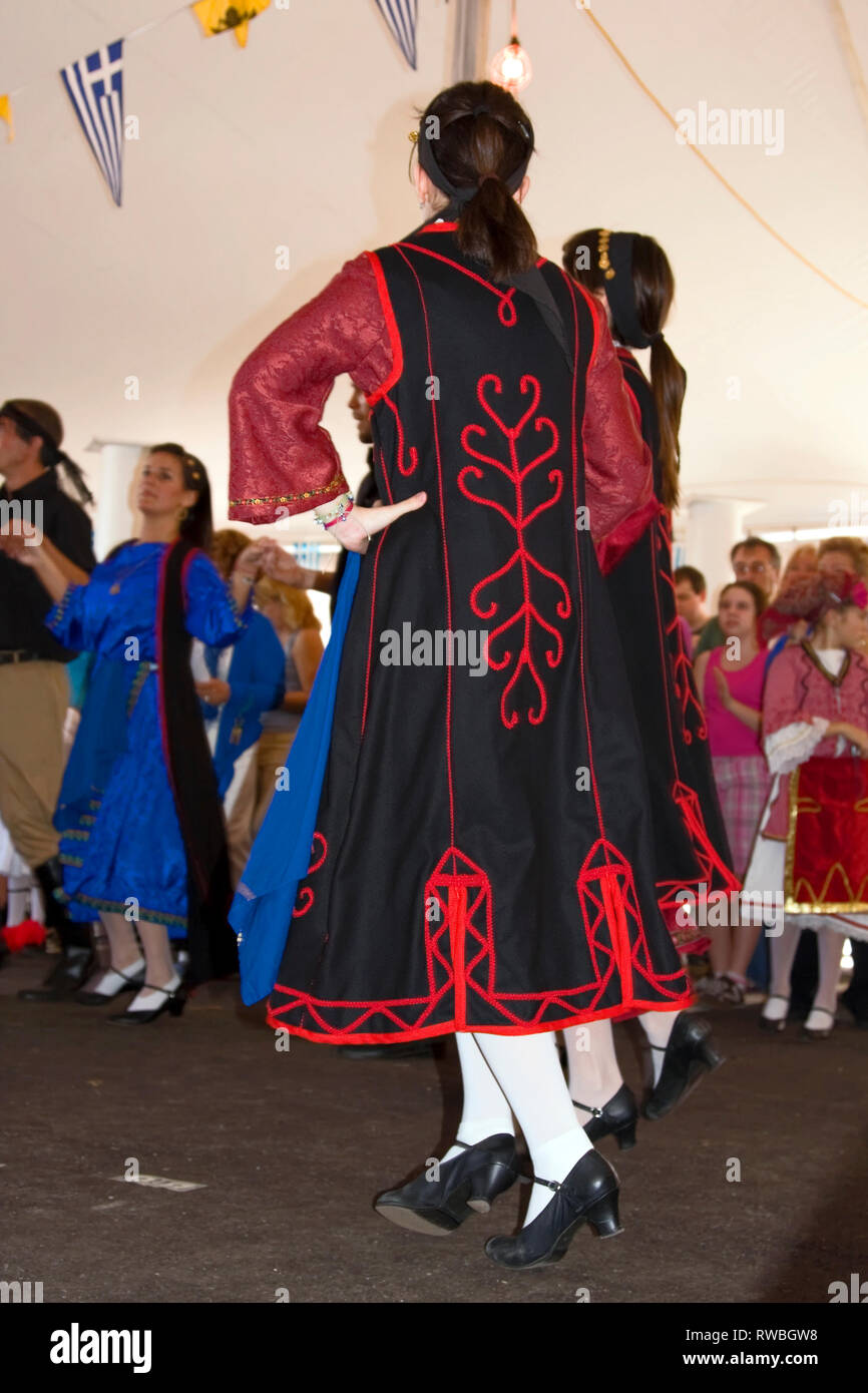 Griechische Festival; junge Frauen tanzen; Trachten; Schwarz, Rot, Verkleidung Flaggen; Zelt; ethnische Feier, Port Charlotte, Fl; Florida; Vertikal Stockfoto